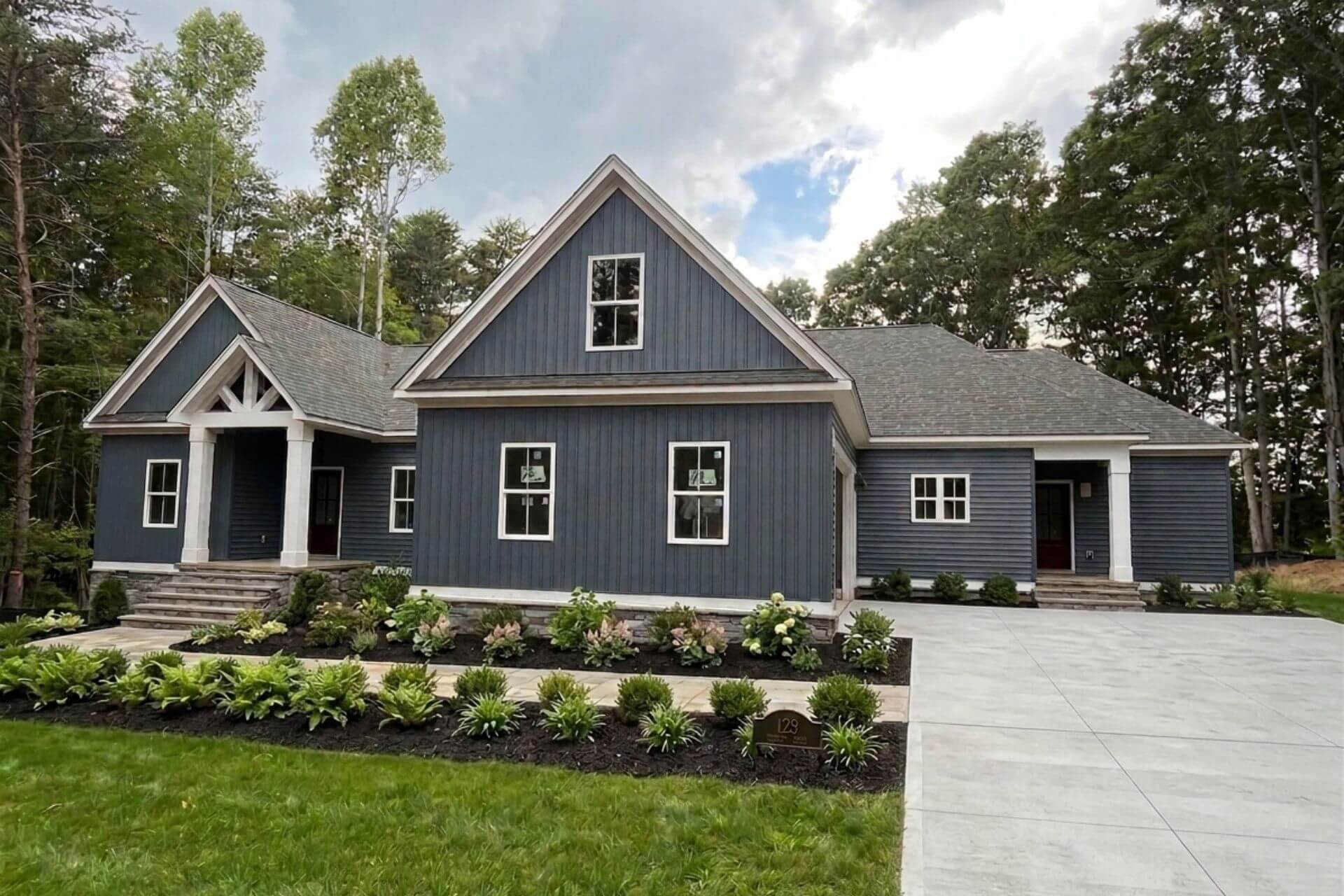 a blue craftsman style home built by mike palmer homes